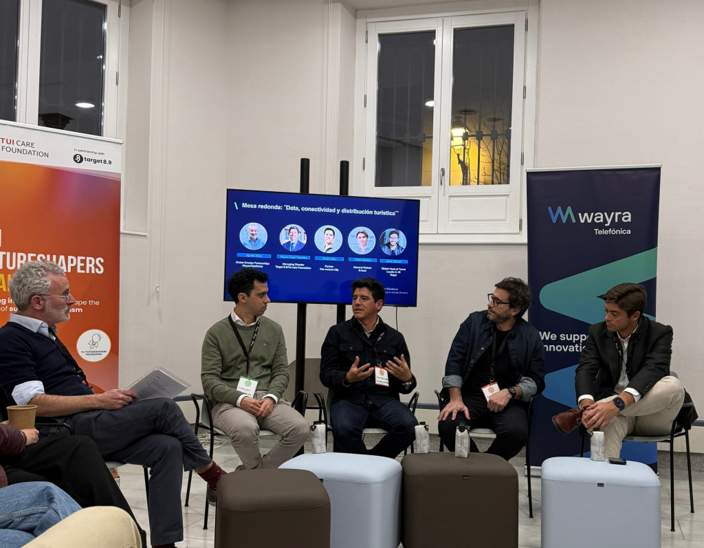 panelists sitting in a circle and one is talking