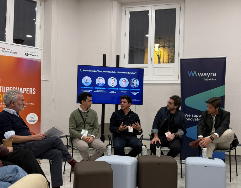 panelists sitting in a circle and one is talking