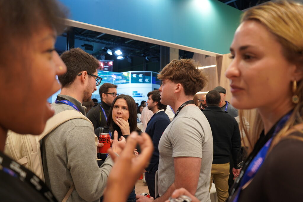 People standing at a fair and discussing and chatting