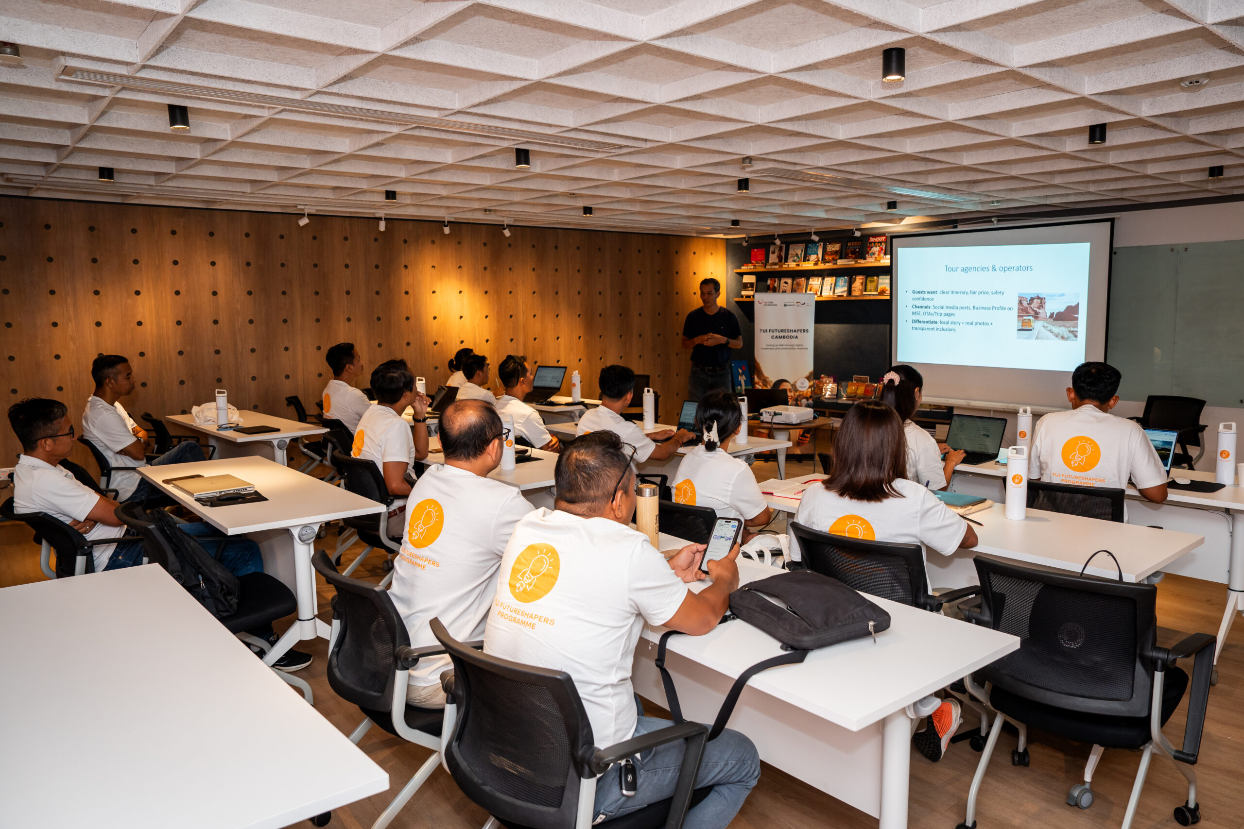 People sitting in a classroom listing to a speaker