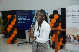 A woman with a microphone holds an emotional speech