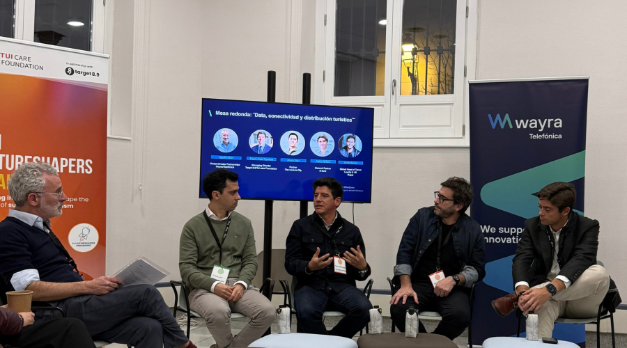 panelists sitting in a circle and one is talking